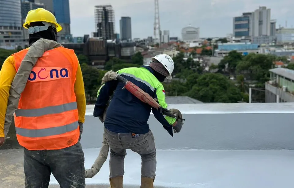 Spray-applied polyurea membrane being applied on a roof